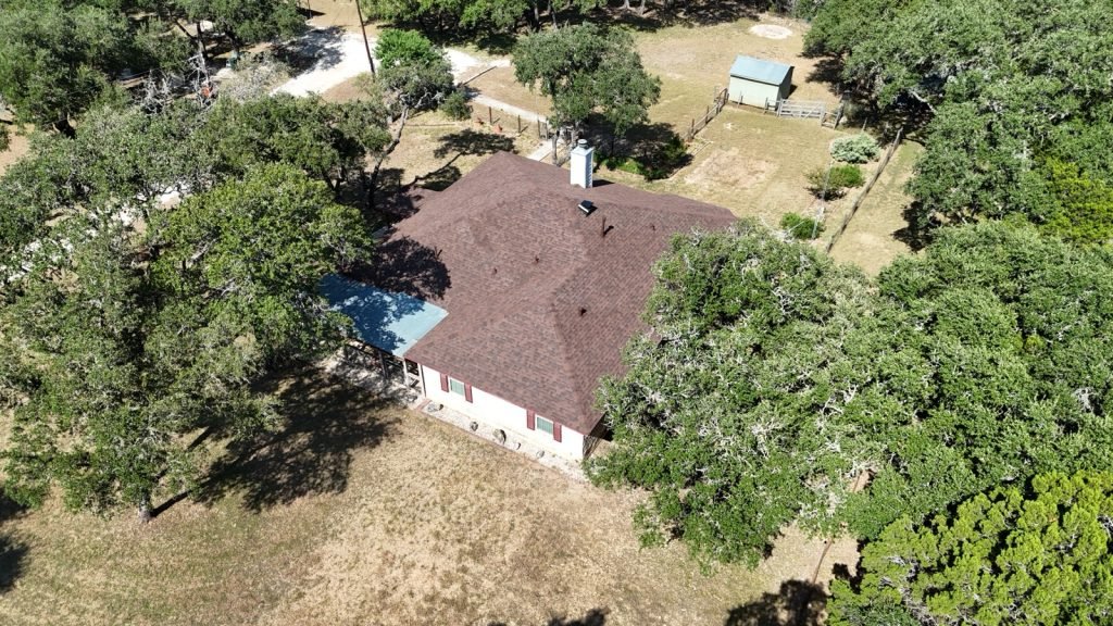 Finished shingle roof, fascia and gutter line on a Texas Hill Country home