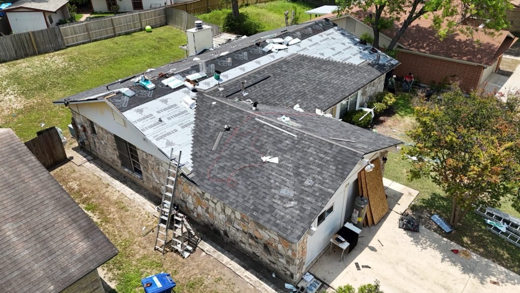 Roofing crew installing underlayment and shingles during a San Antonio roof repair