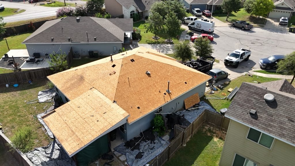 Roof tear-off complete with fresh decking exposed before a new roof installation in San Antonio