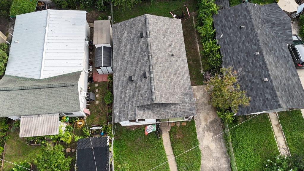Shingle and standing-seam metal roof systems side by side
