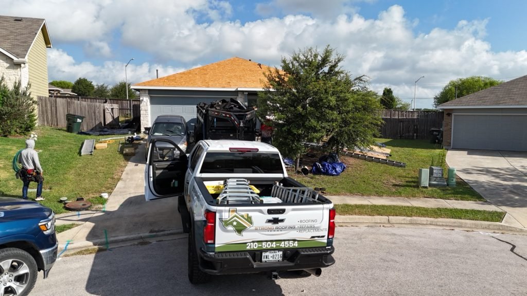 Strong Roofing Texas truck loaded with materials at a San Antonio job site